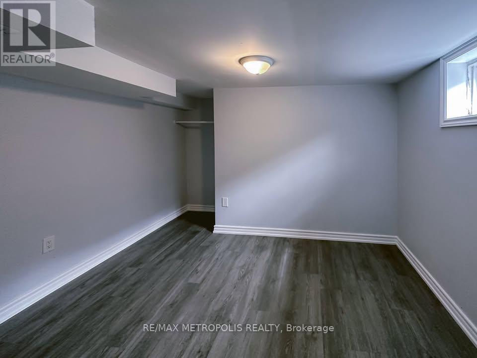 A room with grey flooring and white walls.