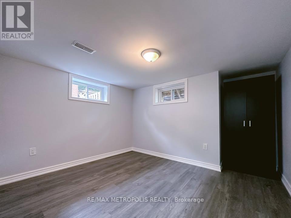 A room with a door, a window, and a light fixture.