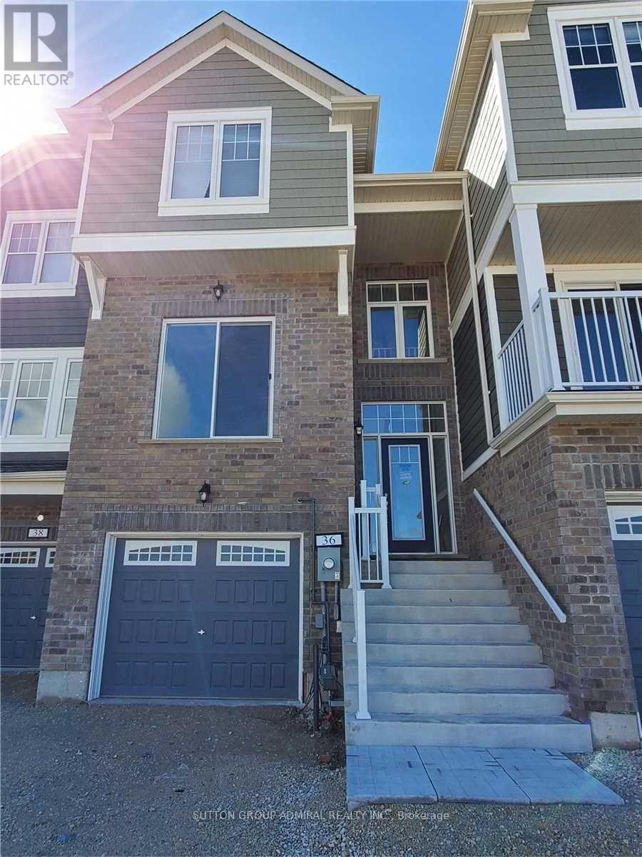 A house with a garage door and a staircase leading to the front door.
