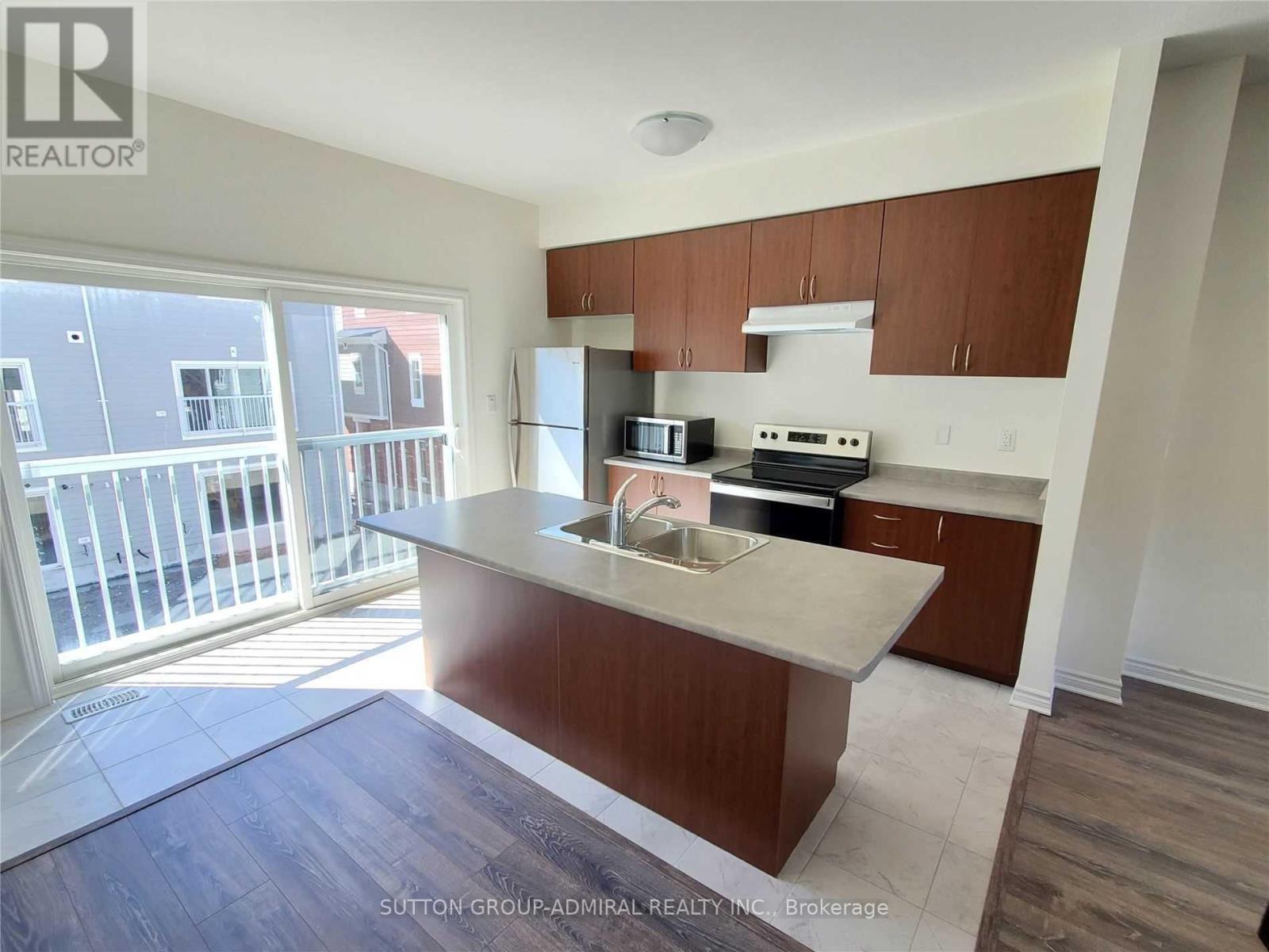 A kitchen with brown cabinets and a white countertop.