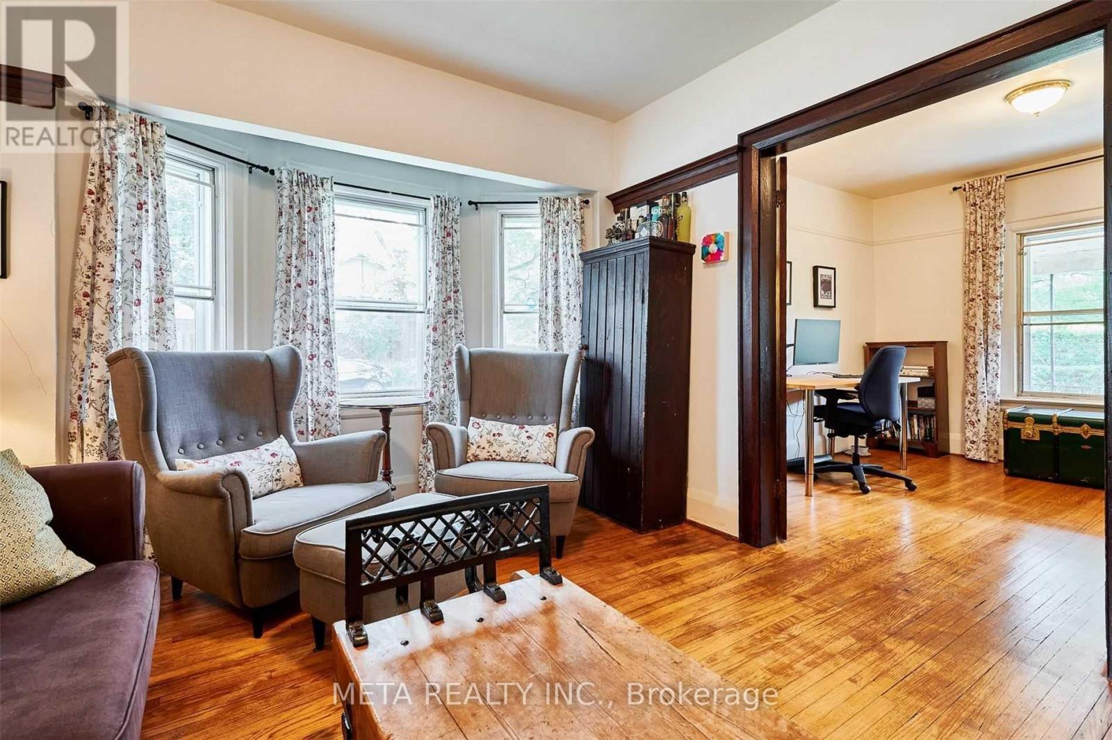 A living room with a brown leather chair and a wooden coffee table.