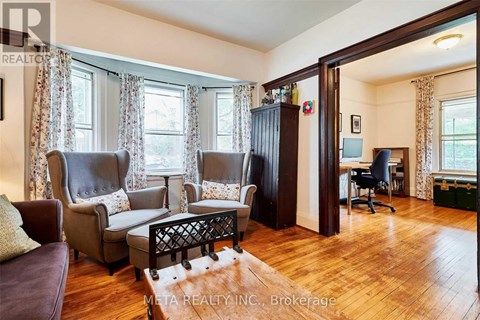 A living room with a brown leather chair and a wooden coffee table.