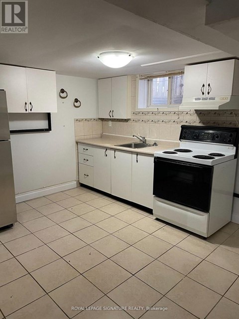 A kitchen with white cabinets and appliances.
