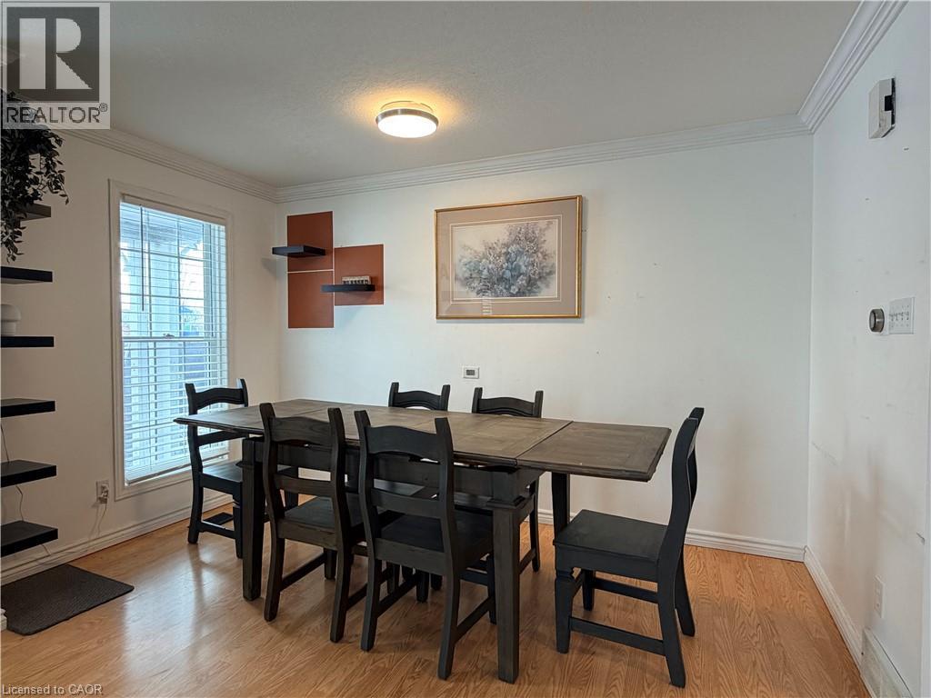 A dining room with a wooden table and chairs.