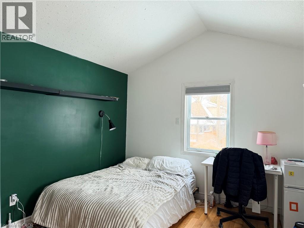 A bedroom with a bed, desk, and chair.