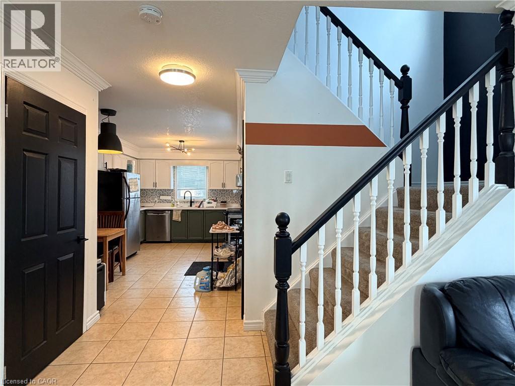 A living room with a couch and a staircase.