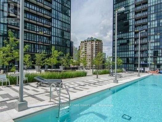 A swimming pool in a city setting surrounded by buildings.