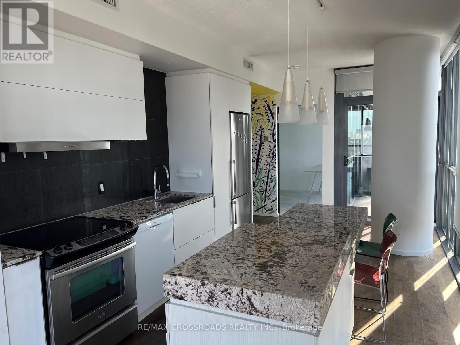 A kitchen with granite countertops and stainless steel appliances.