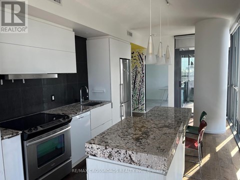 A kitchen with granite countertops and stainless steel appliances.