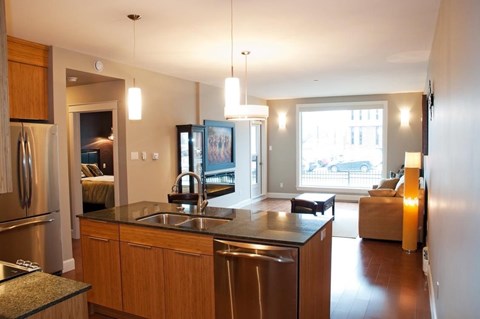 A modern kitchen with wooden cabinets and stainless steel appliances.