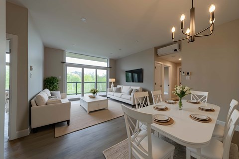 A dining room with a white table and chairs.