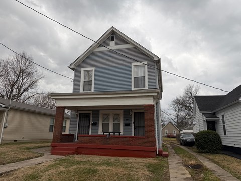 A blue house with a red front porch.