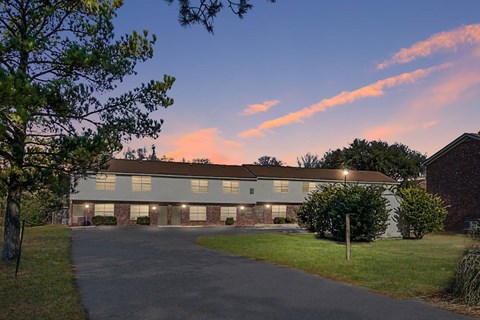 A building with a driveway in front of it.