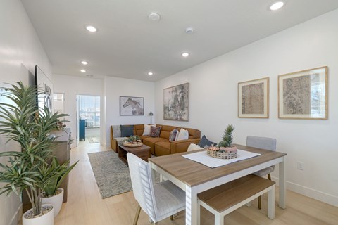 A well-lit dining area with a wooden table and chairs.