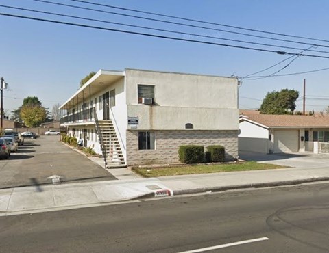 A concrete building with a staircase leading to the entrance.