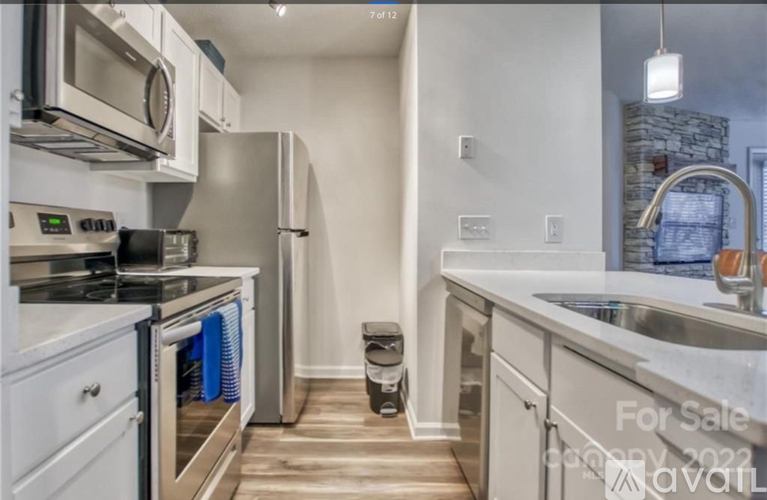 A kitchen with a stove top oven and a refrigerator.