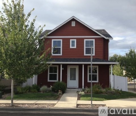 A red house with a white door and windows.