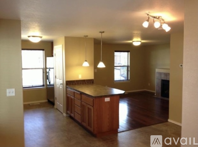 A kitchen with wooden cabinets and a countertop is available for rent.