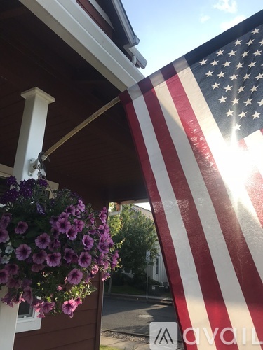 A large American flag hangs on a building.