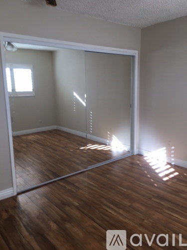 A room with wooden floors and a sliding glass door.