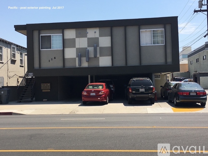 A modern building with a checkered pattern on the side is painted in black and white.