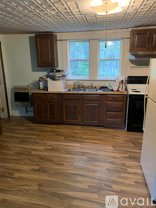 A kitchen with wooden cabinets and a white refrigerator.