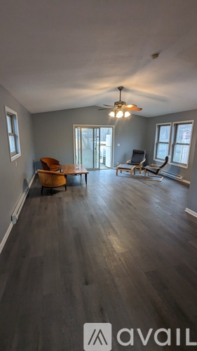A living room with a brown chair and a brown couch.
