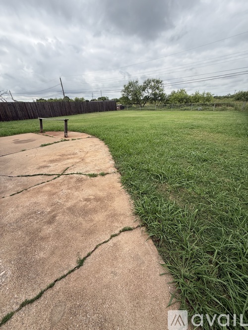 A concrete pathway leads through a grassy area.