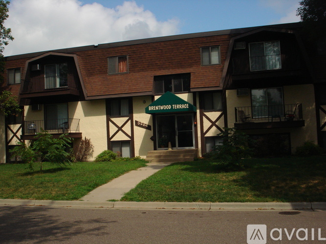 A building with a green sign that says Brentwood Terrace.