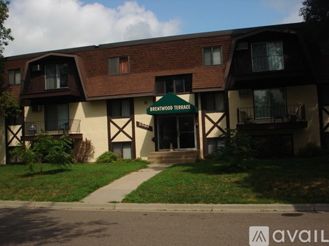 A building with a green sign that says Brentwood Terrace.