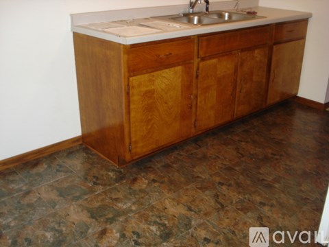 A wooden cabinet with a sink on top.