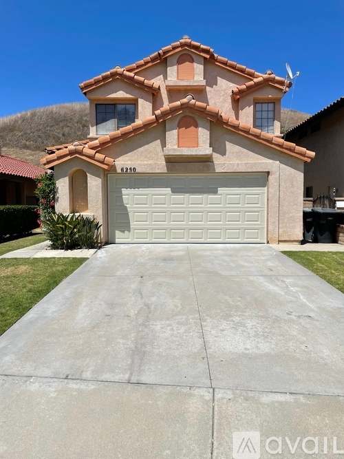A house with a garage and a driveway in front.
