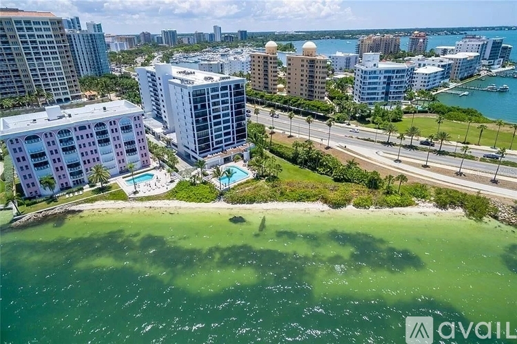 A beachfront view of a city with buildings and a pool.