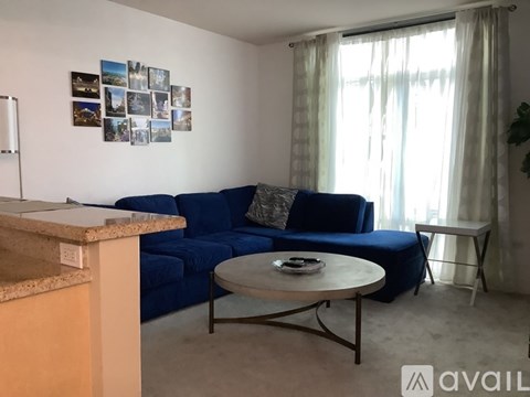 A living room with a blue sofa and a coffee table.