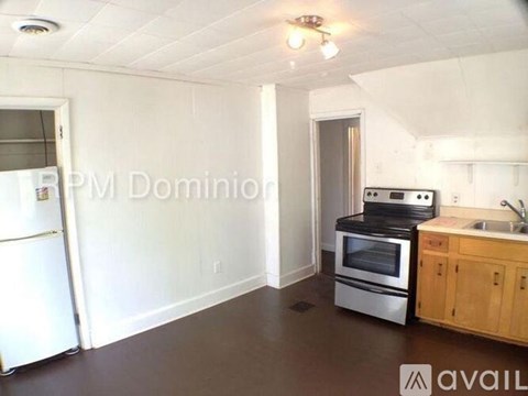 A kitchen with a white fridge, stove, and oven.