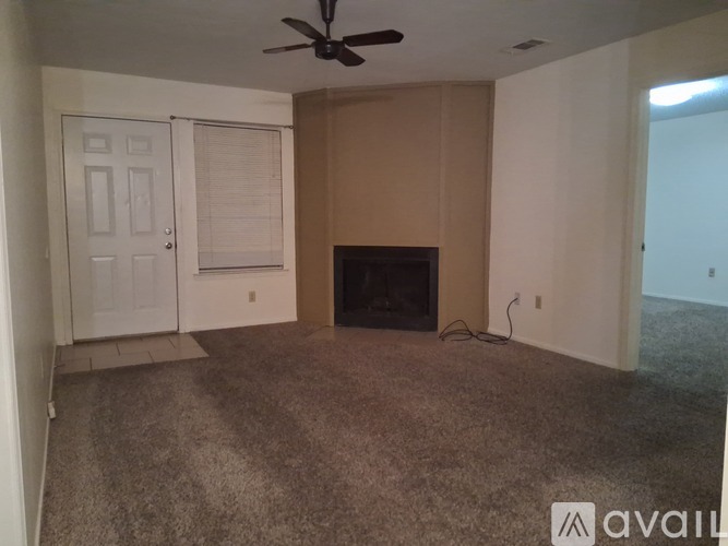 A room with a fireplace and a ceiling fan.