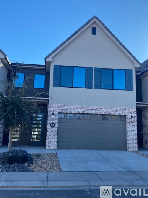 A house with a garage and a driveway in front.