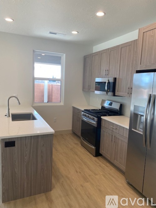 A kitchen with wooden cabinets and stainless steel appliances.