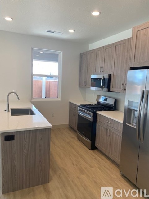 A kitchen with wooden cabinets and stainless steel appliances.