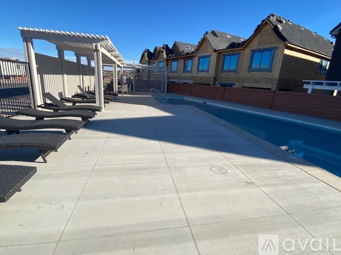 A sunny day at the outdoor pool area of a residential complex.