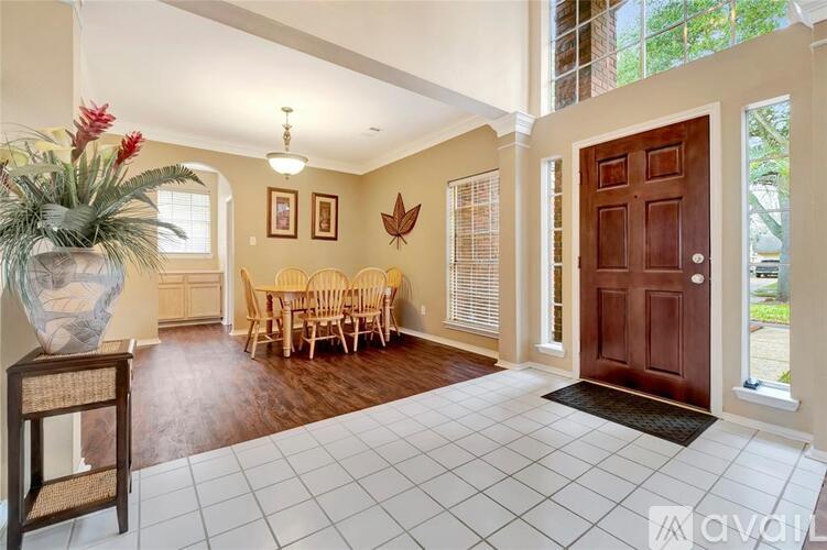 A living room with a brown door and a white tiled floor.