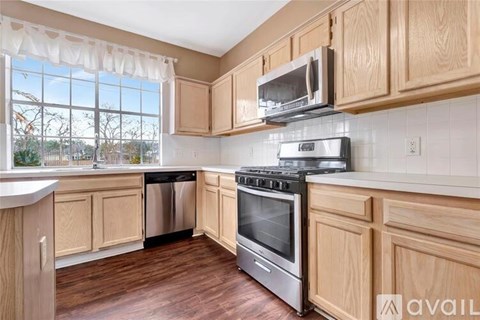 A kitchen with wooden cabinets and stainless steel appliances.