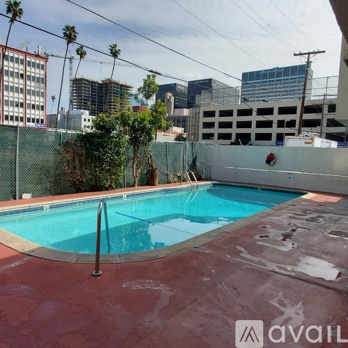 A pool with a red bottom and a fence around it.