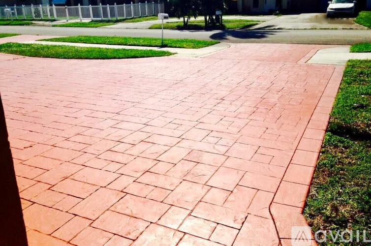 A red brick pathway leads to a grassy area.