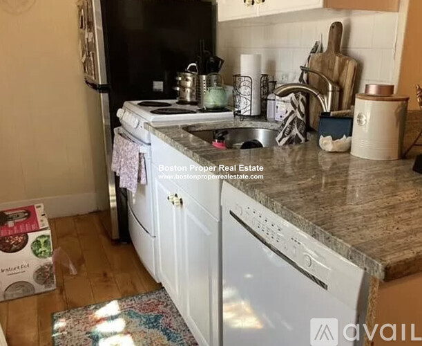 A kitchen with a white dishwasher and a white oven.