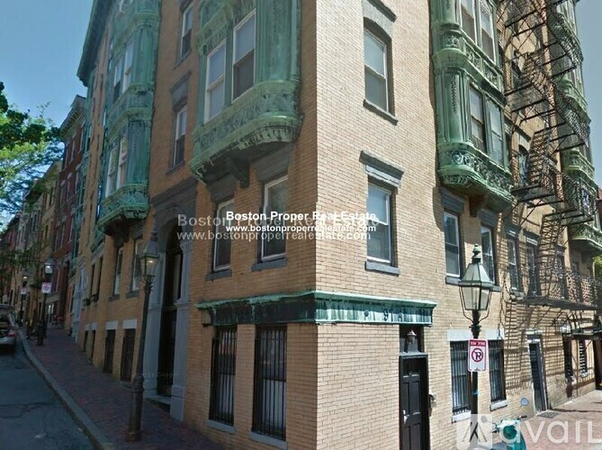 A building with a green awning and a sign that says "Boston.".