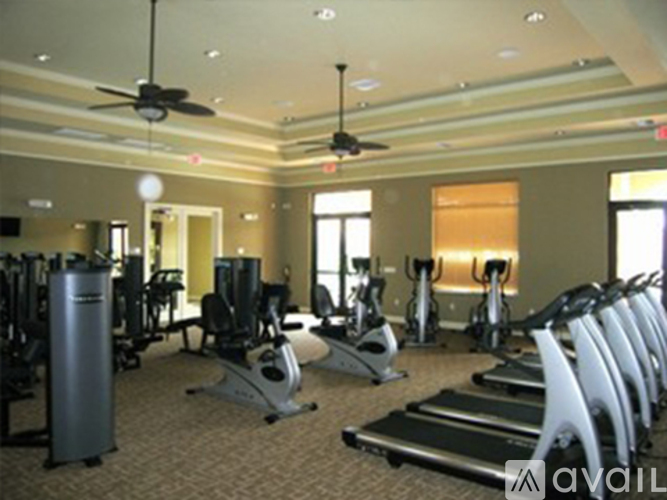 A gym with treadmills, weights, and exercise equipment.