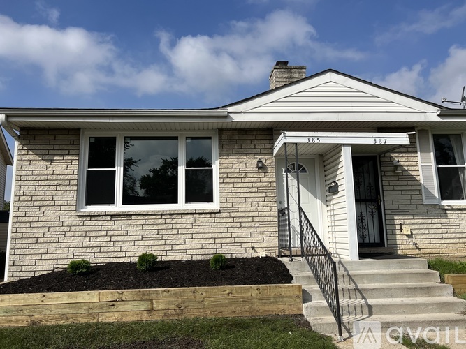 A house with a white front porch and a black railing.