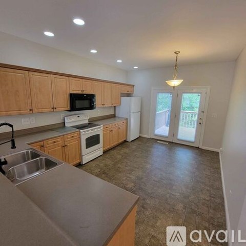 A kitchen with wooden cabinets and a tiled floor.