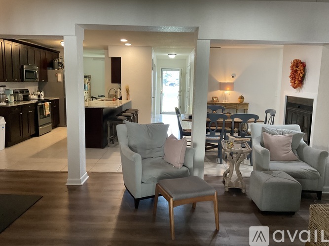 A living room with a couch, chair, and table.